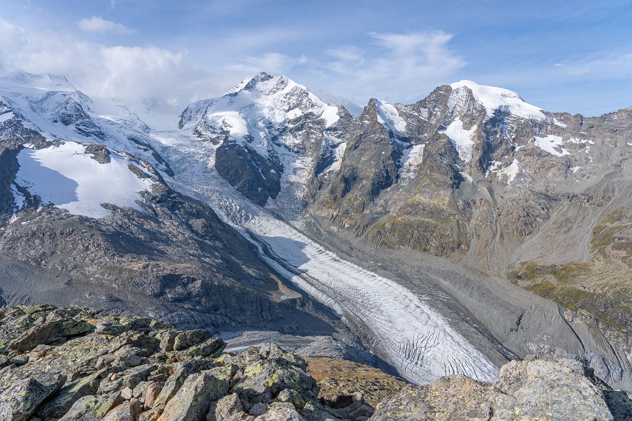 Gletscher mit Spalten und schneebedeckten Berggipfeln